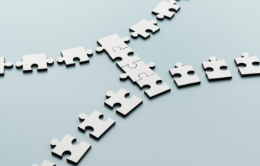 Jigsaw puzzle pieces coming together to signify finance and program partnership for an audit